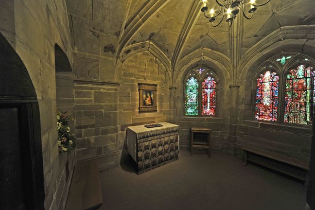 The view of the Audley Chapel from the doorway, to the left hand side is a shrine and to the right are four brightly coloured windows